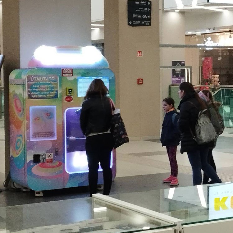 Cotton candy vending machine placed in a busy shopping mall