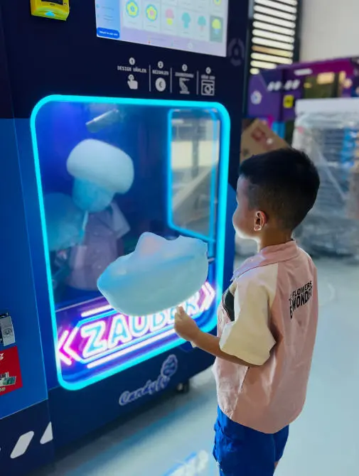Interior view of a vending machine creating a fresh batch of colorful cotton candy